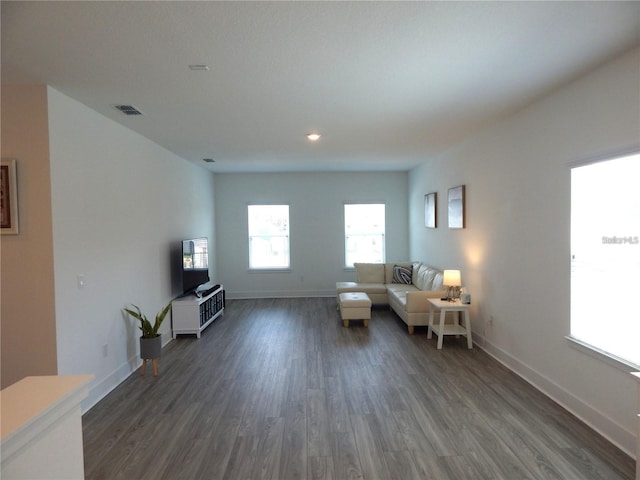 sitting room featuring dark wood-style flooring, baseboards, and recessed lighting