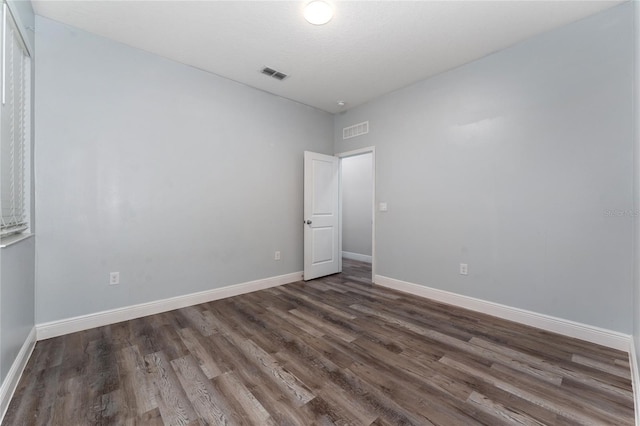 12845 Sawgrass Pine Cir, Orlando, FL 32824 - empty room with dark wood-style flooring and baseboards