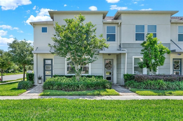 15975 Marina Bay Dr, Winter Garden, FL 34787 - townhome / multi-family property featuring stucco siding and a front lawn