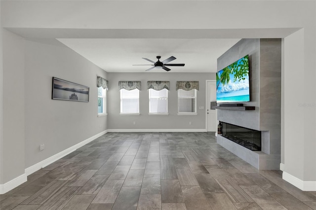 15975 Marina Bay Dr, Winter Garden, FL 34787 - unfurnished living room with a fireplace, a ceiling fan, and baseboards