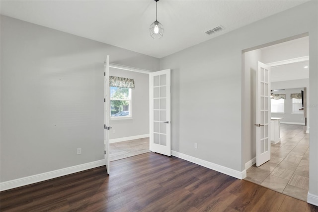 15975 Marina Bay Dr, Winter Garden, FL 34787 - spare room with french doors, wood finished floors, and baseboards