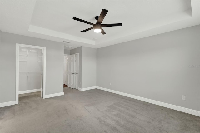 15975 Marina Bay Dr, Winter Garden, FL 34787 - unfurnished bedroom featuring a raised ceiling, a walk in closet, carpet, baseboards, and a closet