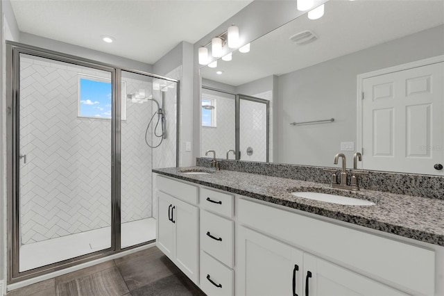 15975 Marina Bay Dr, Winter Garden, FL 34787 - bathroom with a shower stall, double vanity, healthy amount of natural light, tile patterned floors, and recessed lighting