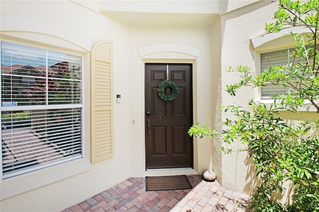 6941 Piazza St, Orlando, FL 32819 - doorway to property featuring stucco siding
