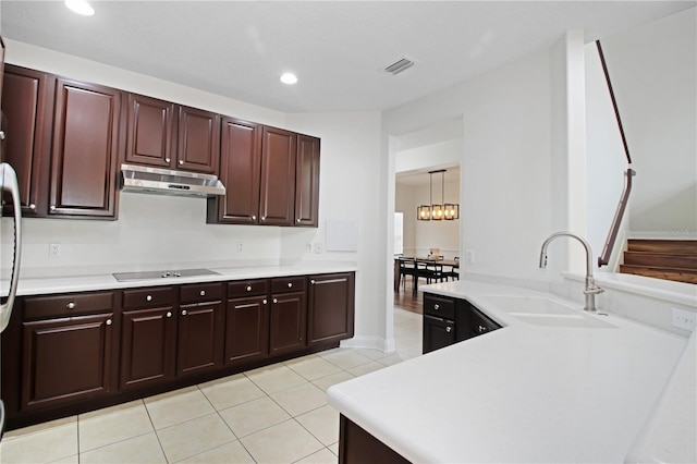 6941 Piazza St, Orlando, FL 32819 - kitchen with under cabinet range hood, a sink, light tile patterned flooring, light countertops, and recessed lighting