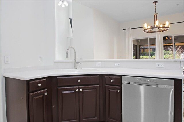 6941 Piazza St, Orlando, FL 32819 - kitchen featuring dishwasher, a sink, a chandelier, dark brown cabinetry, and light countertops