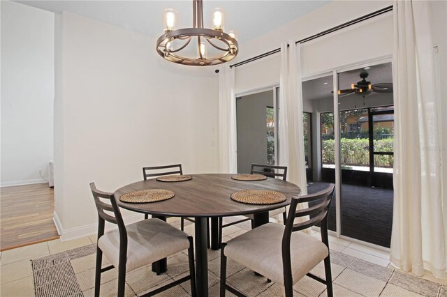 6941 Piazza St, Orlando, FL 32819 - dining area featuring a chandelier, light tile patterned flooring, baseboards, and ceiling fan