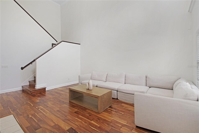 6941 Piazza St, Orlando, FL 32819 - living room featuring stairs, wood finished floors, and baseboards