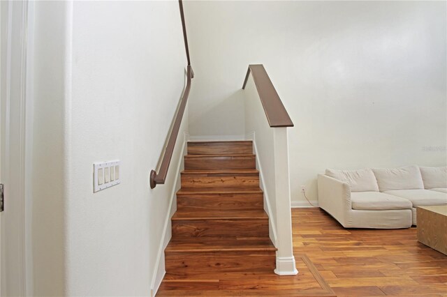 6941 Piazza St, Orlando, FL 32819 - staircase with wood finished floors and baseboards