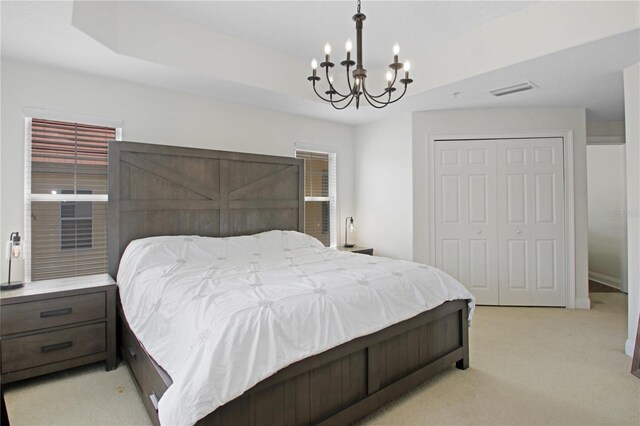 6941 Piazza St, Orlando, FL 32819 - bedroom with a chandelier, a closet, and light colored carpet