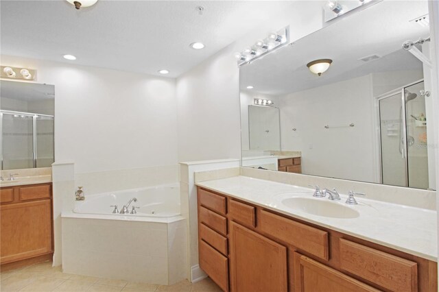 6941 Piazza St, Orlando, FL 32819 - full bath featuring a shower stall, a bath, tile patterned floors, two vanities, and recessed lighting
