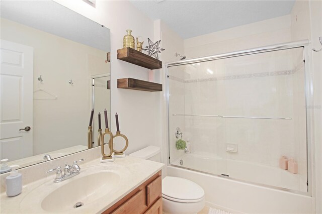 6941 Piazza St, Orlando, FL 32819 - bathroom with toilet, vanity, and bath / shower combo with glass door