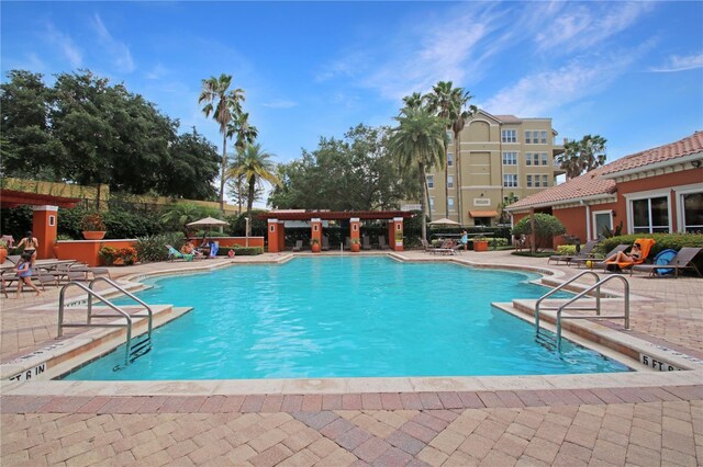 6941 Piazza St, Orlando, FL 32819 - community pool with a patio