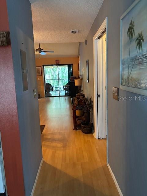 25306 Northlake Dr Unit 25306, Sanford, FL 32773 - corridor featuring a textured ceiling and light wood-style floors