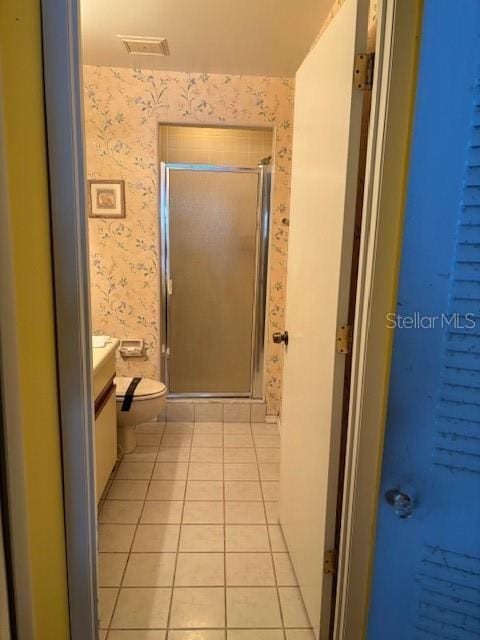 25306 Northlake Dr Unit 25306, Sanford, FL 32773 - full bathroom featuring wallpapered walls, vanity, tile patterned floors, toilet, and a shower stall