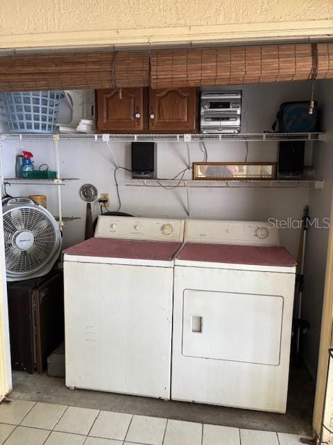 25306 Northlake Dr Unit 25306, Sanford, FL 32773 - laundry room with washing machine and dryer, light tile patterned flooring, and cabinet space