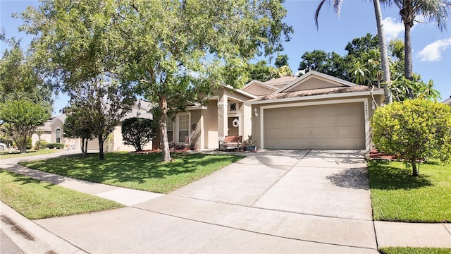 2343 Walnut Heights Rd, Apopka, FL 32703 - view of front of home with stucco siding, a garage, concrete driveway, and a front yard