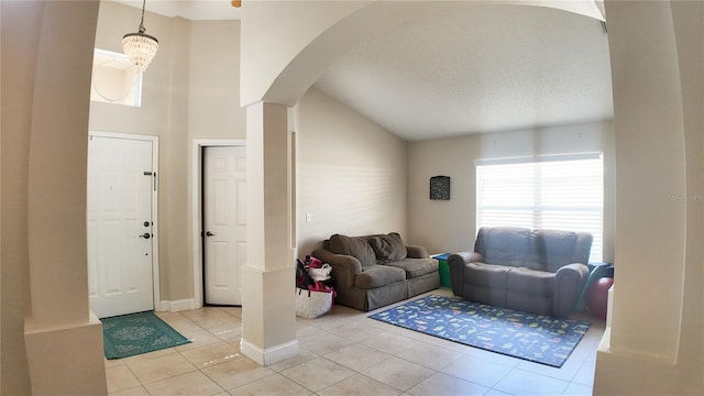 2343 Walnut Heights Rd, Apopka, FL 32703 - entryway with arched walkways, light tile patterned flooring, vaulted ceiling, and a textured ceiling