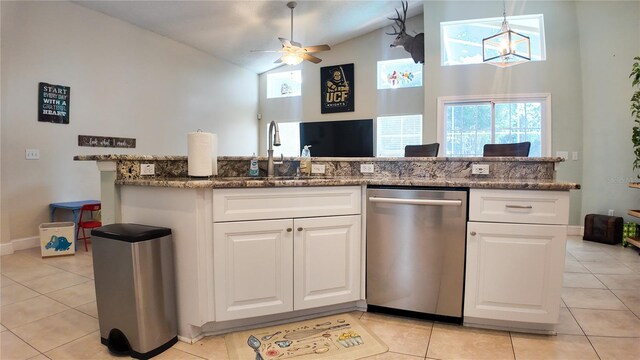 2343 Walnut Heights Rd, Apopka, FL 32703 - kitchen with dishwasher, light tile patterned flooring, a sink, high vaulted ceiling, and white cabinets