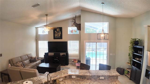 2343 Walnut Heights Rd, Apopka, FL 32703 - living room featuring ceiling fan, vaulted ceiling, a textured ceiling, plenty of natural light, and light tile patterned flooring