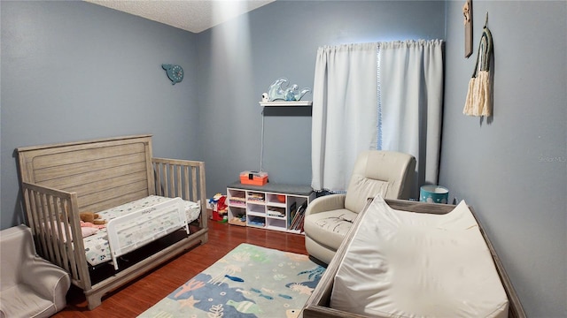 2343 Walnut Heights Rd, Apopka, FL 32703 - bedroom with a nursery area and wood finished floors