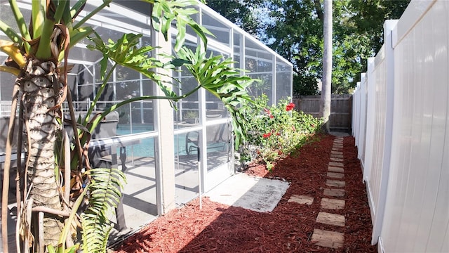 2343 Walnut Heights Rd, Apopka, FL 32703 - view of property exterior with a fenced backyard and glass enclosure