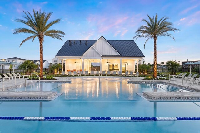 1664 Crowncrest Dr, Apopka, FL 32703 - pool at dusk with a patio, a community pool, and ceiling fan