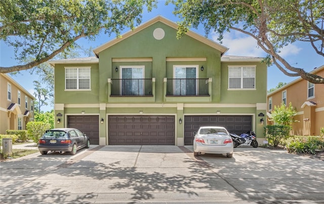 2430 Little Gem Loop, Sanford, FL 32773 - townhome / multi-family property featuring concrete driveway, stucco siding, and an attached garage
