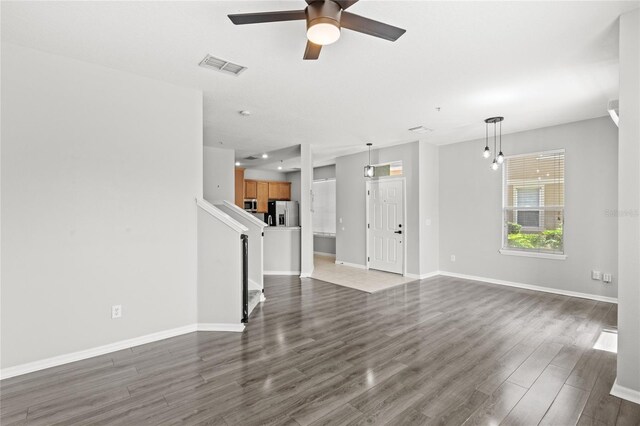 2430 Little Gem Loop, Sanford, FL 32773 - unfurnished living room with ceiling fan, dark wood finished floors, and baseboards