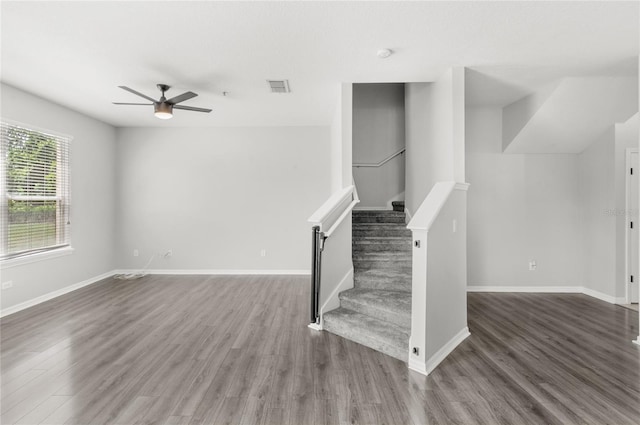 2430 Little Gem Loop, Sanford, FL 32773 - unfurnished living room with a ceiling fan, wood finished floors, stairway, and baseboards