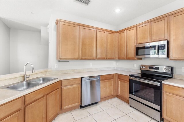 2430 Little Gem Loop, Sanford, FL 32773 - kitchen featuring appliances with stainless steel finishes, a sink, light tile patterned floors, light countertops, and recessed lighting