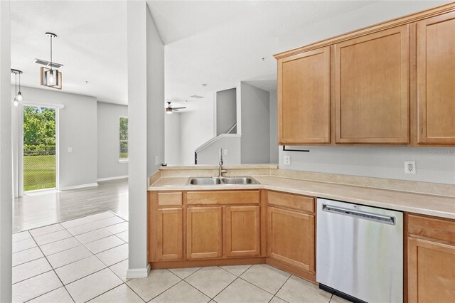 2430 Little Gem Loop, Sanford, FL 32773 - kitchen featuring dishwasher, a sink, light tile patterned floors, light countertops, and baseboards