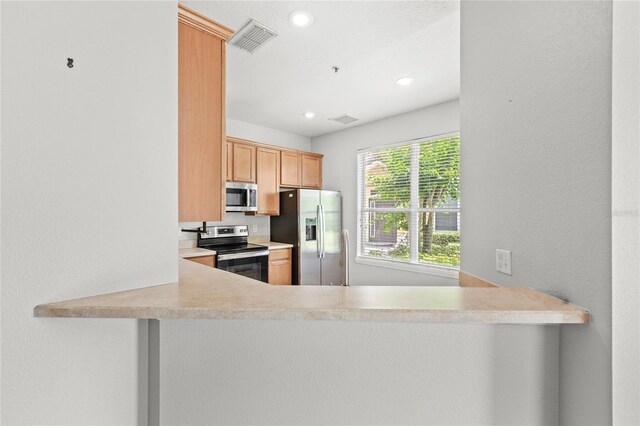 2430 Little Gem Loop, Sanford, FL 32773 - kitchen featuring stainless steel appliances, recessed lighting, a peninsula, and light countertops