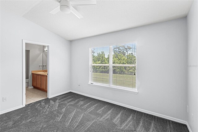 2430 Little Gem Loop, Sanford, FL 32773 - unfurnished bedroom featuring carpet, lofted ceiling, connected bathroom, baseboards, and a sink