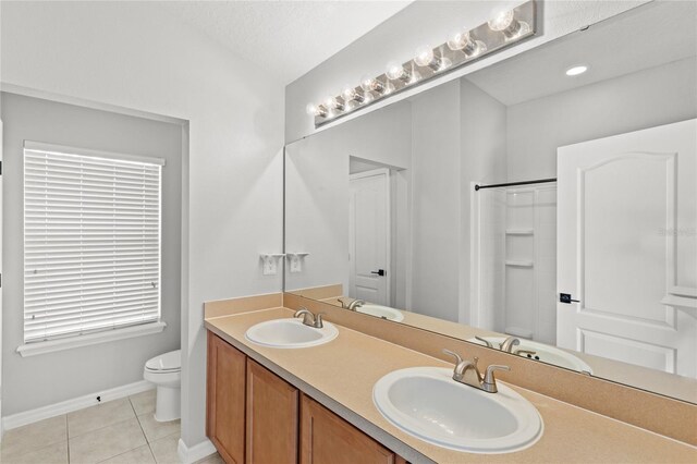 2430 Little Gem Loop, Sanford, FL 32773 - full bathroom with toilet, tile patterned floors, a shower, baseboards, and double vanity