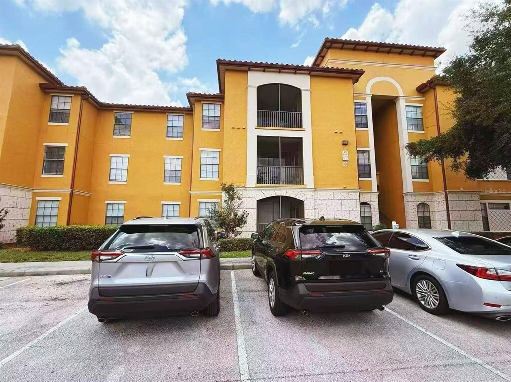 6169 Metrowest Blvd Unit 308, Orlando, FL 32835 - view of building exterior with uncovered parking