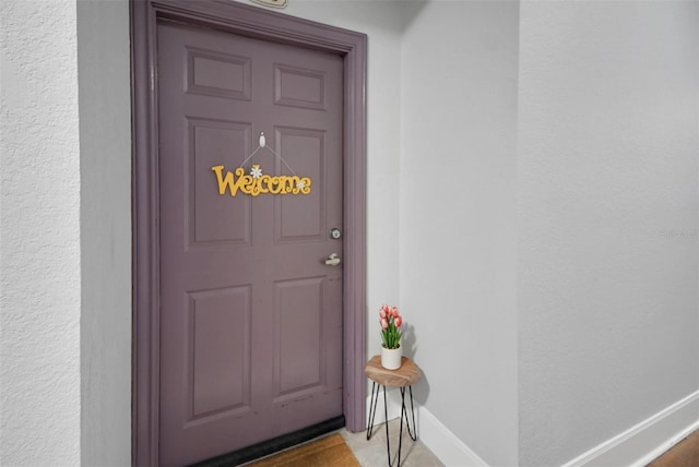 doorway to property featuring stucco siding