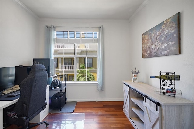 home office with wood finished floors, crown molding, and baseboards