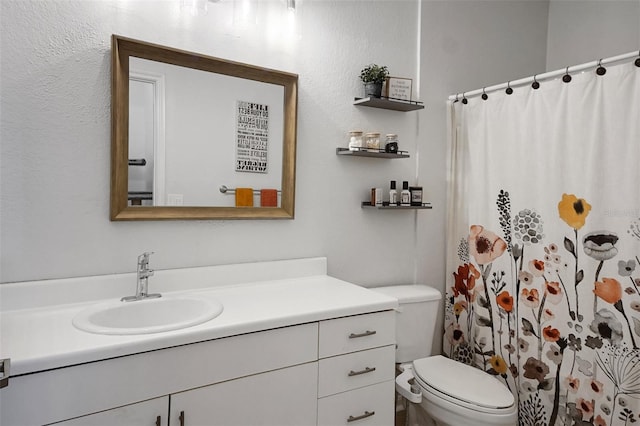 bathroom featuring vanity, toilet, and a shower with shower curtain