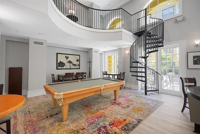 playroom featuring healthy amount of natural light, wood finished floors, billiards table, and a high ceiling