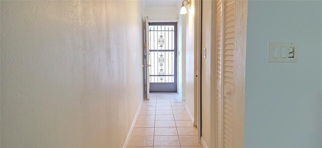1504 Virginia Ave Unit 105, Daytona Beach, FL 32114 - hallway featuring light tile patterned floors, crown molding, and baseboards