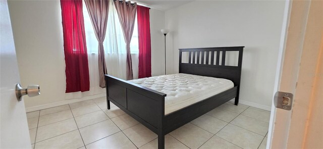 1504 Virginia Ave Unit 105, Daytona Beach, FL 32114 - bedroom with baseboards and tile patterned floors