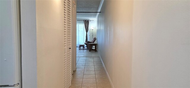 1504 Virginia Ave Unit 105, Daytona Beach, FL 32114 - hallway with baseboards, light tile patterned floors, and a textured ceiling