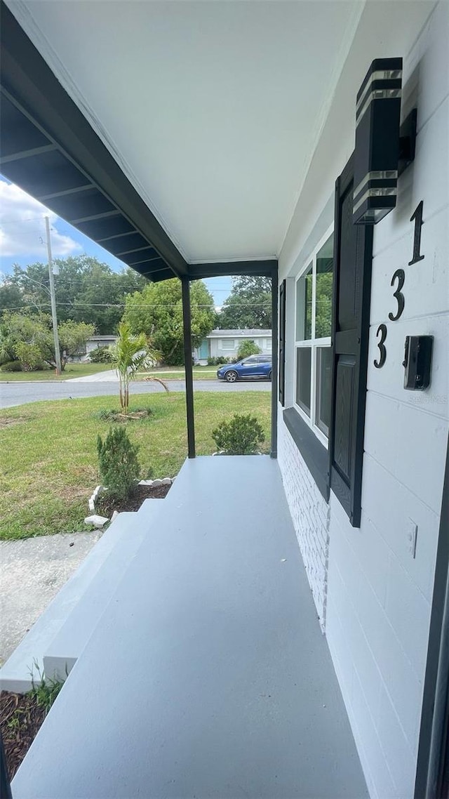 331 N Dollins Ave, Orlando, FL 32805 - porch featuring a yard