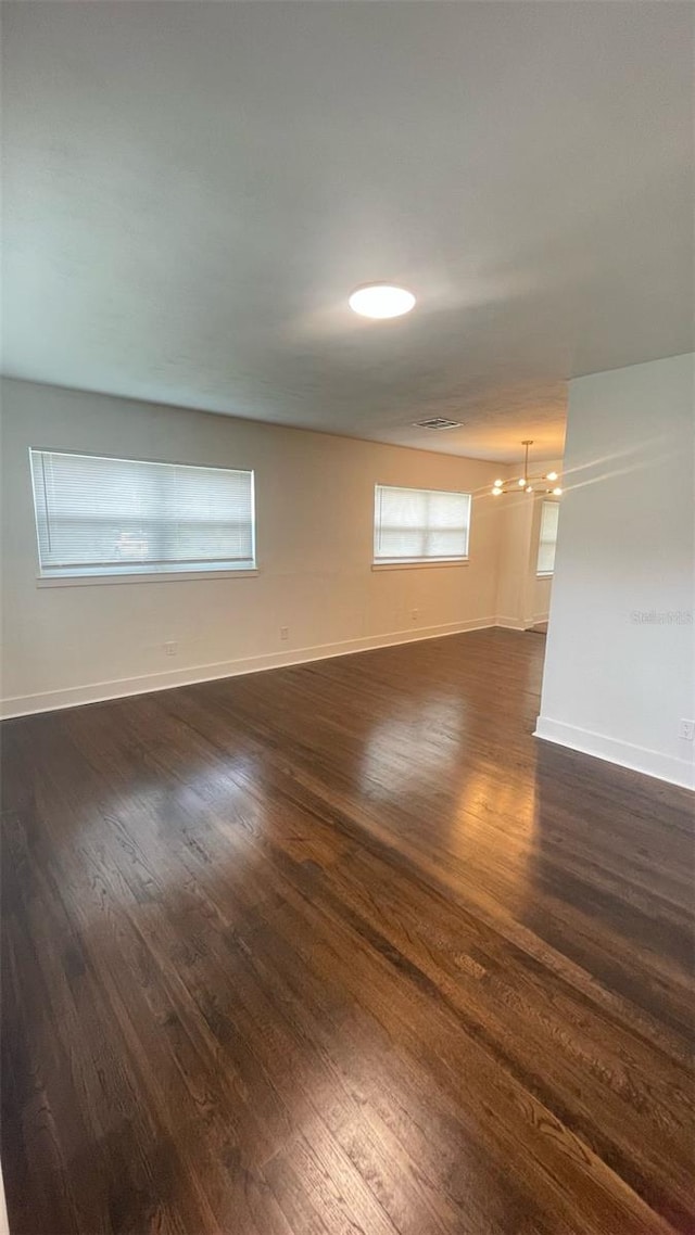 331 N Dollins Ave, Orlando, FL 32805 - empty room featuring dark wood-style flooring and a chandelier