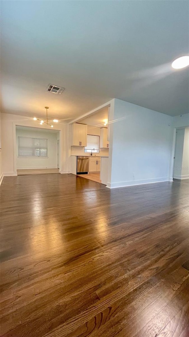 331 N Dollins Ave, Orlando, FL 32805 - unfurnished living room featuring dark wood-style floors and baseboards