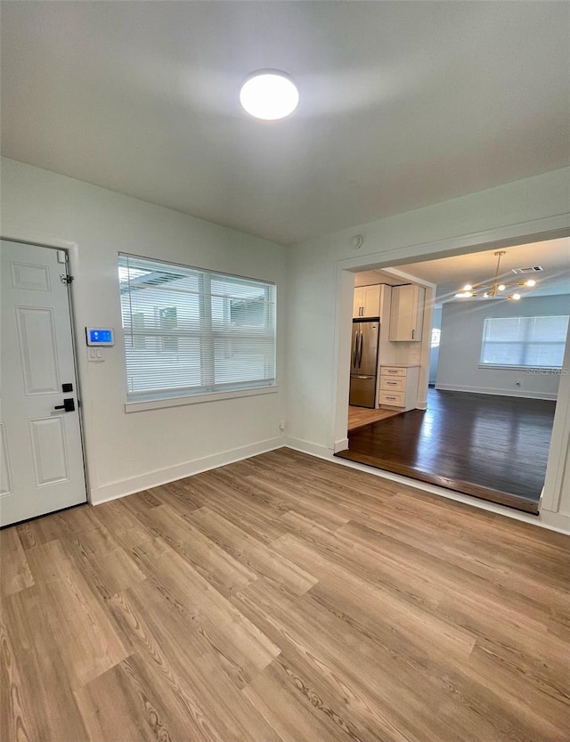 331 N Dollins Ave, Orlando, FL 32805 - foyer entrance with light wood-type flooring and baseboards