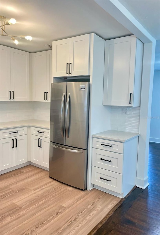 331 N Dollins Ave, Orlando, FL 32805 - kitchen with freestanding refrigerator, light wood-type flooring, decorative backsplash, and light countertops
