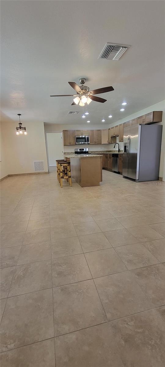 122 N Cedarview Ter, Inverness, FL 34453 - kitchen featuring appliances with stainless steel finishes, light tile patterned floors, ceiling fan, recessed lighting, and a sink