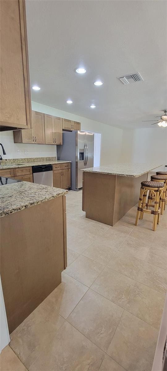 122 N Cedarview Ter, Inverness, FL 34453 - kitchen featuring stainless steel appliances, light stone countertops, ceiling fan, recessed lighting, and light tile patterned flooring